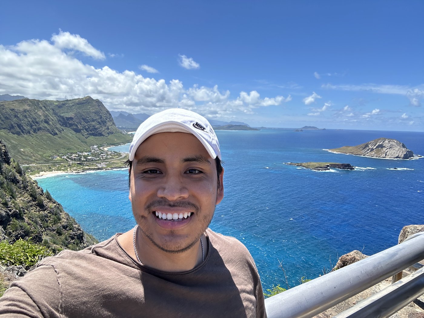 Fredy smiling at a coastal overlook